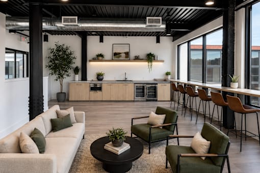 A modern living room with a large couch, chairs, and a coffee table.