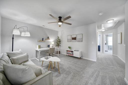 Open-concept living space with grey carpet and white sofa in Indian Trail, NC pet-friendly townhome