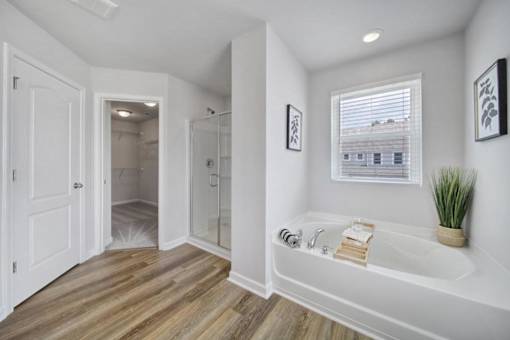 Bright bathroom with large soaking tub and window in Indian Trail pet-friendly townhome