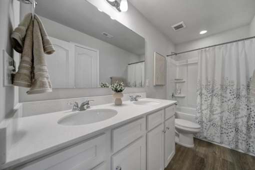 Bathroom with double sinks and shower in pet-friendly townhome in Indian Trail, NC
