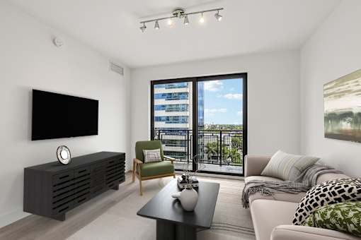 Bright open-concept living room at MB Station with oversized windows, contemporary finishes, and city views in Miami's Coral Way neighborhood near Brickell.