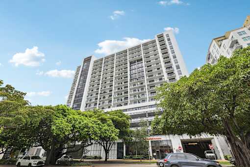 Luxury high-rise exterior of MB Station apartments in Miami's Coral Way neighborhood, offering modern studio, one-, and two-bedroom apartment homes near Brickell and Coral Gables.