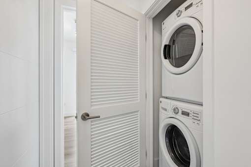 In-home front-loading washer and dryer at MB Station apartments in Miami, providing added convenience for everyday living.