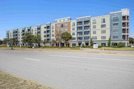 Pet-Friendly Rentals in North Little Rock, AR – Metropolitan – A row of apartment buildings with trees in front.
