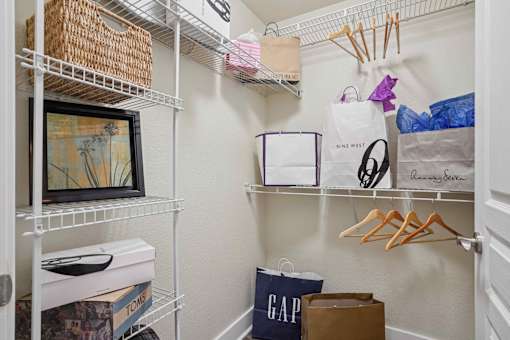 Pet-Friendly Rentals in North Little Rock, AR – Metropolitan – A white closet with a GAP bag and a MINE WEST bag.