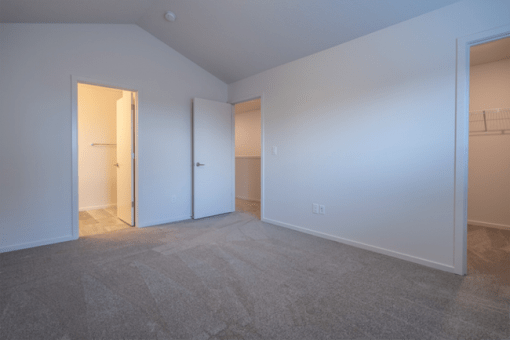 Vancouver, WA, Apartments Near Legacy Salmon Creek Hospital - Minnehaha Meadows - An Empty Bedroom with Carpet Flooring, Recessed Lighting, and Large Closet Area.