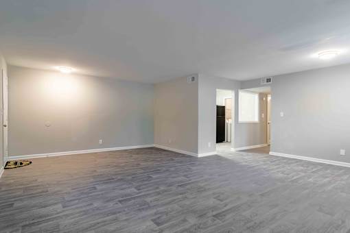 Unfurnished living space with large window and wood-style plank floors near Briarcliff.
