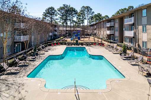Swimming pool with lounge seating at Mirador at Peachtree Apartments near Briarcliff in Atlanta.