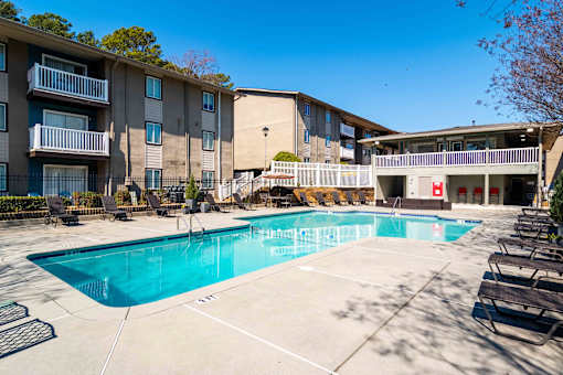 Swimming pool with sundeck and seating in community-oriented Atlanta apartments