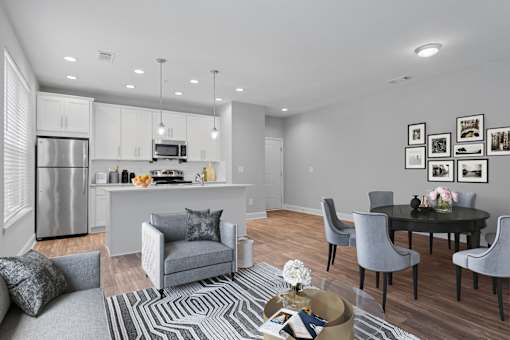 Open-concept living room and kitchen with wood-style flooring at apartments near Briarcliff, Atlanta.
