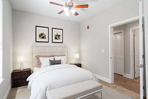 Bedroom with framed wall art and access to private bathroom at Mirador at Peachtree.