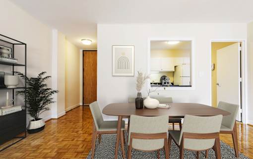 A dining room with a wooden table and chairs.