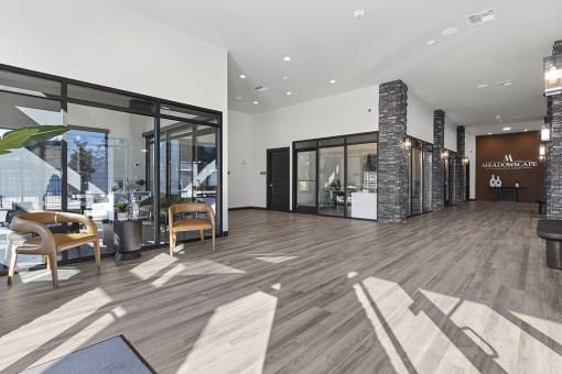 a large lobby with wood floors and glass doors,