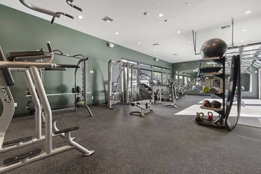 a spacious fitness center with exercise equipment,