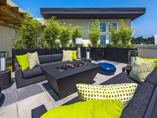 Seattle, WA, Apartments with In-Unit Washer and Dryer - Origin - Firepit with Lounge Seating and Outdoor Lamps on Rooftop Patio