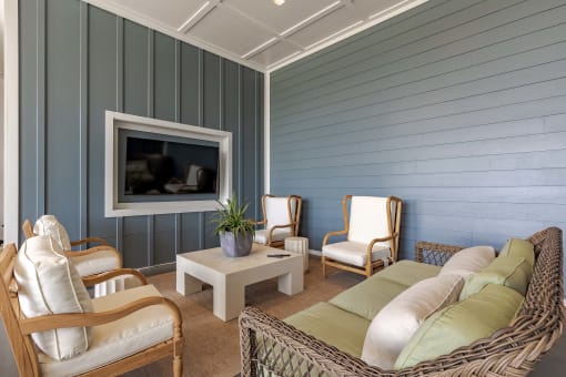 a living room with blue walls and a couch and chairs