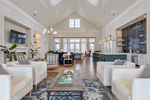 a large living room with white couches and a coffee table