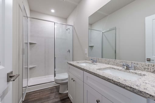 a bathroom with a sink and a shower and a toilet