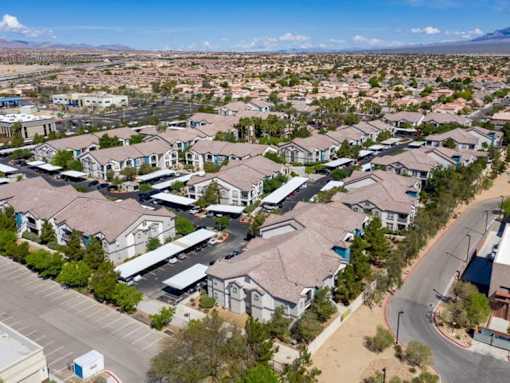 A large residential complex with multiple houses and a parking lot.