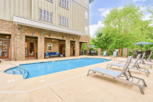 large resort style swimming pool with lounge chairs