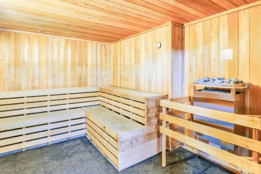 sauna room with two rows of wood bench seating