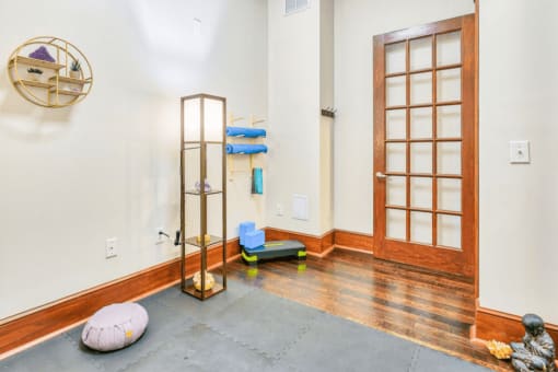 yoga room with hardwood floors and glass wood paneled doors