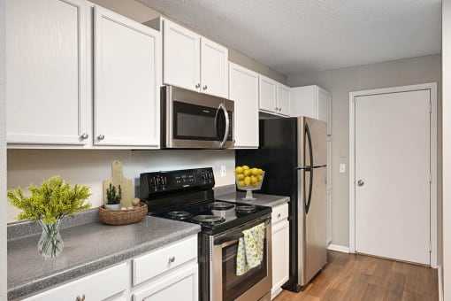 Burnsville, MN Townhomes – Summit Townhomes - modern kitchen with white cabinets and stainless steel appliances