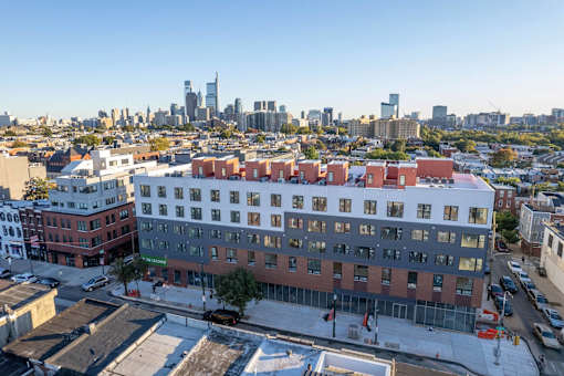 an aerial view of a building with a city in the background