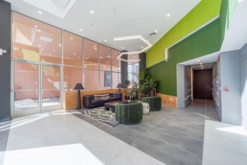 A modern interior with a glass wall and a green accent wall.