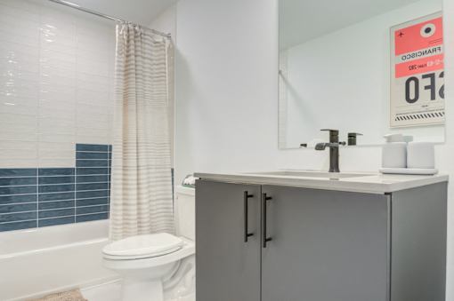 a bathroom with a sink and a toilet and a shower