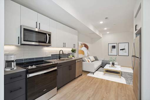 A modern kitchen with dark wood cabinets and stainless steel appliances.