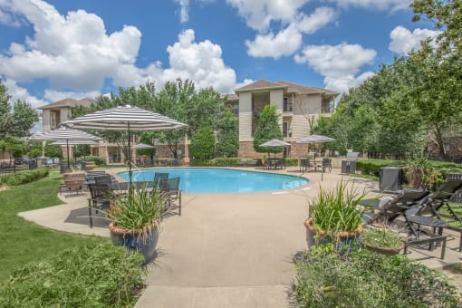 Affordable Houston Texas Apartments – Westchase Forest – Photo of a swimming pool with patio furniture and umbrellas