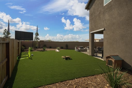 Roseville, CA Fully Furnished Single Family Homes for Rent - Vera at Fiddyment - Private Fenced Backyard with Cornhole Boards, Mini Soccer Goal, and Plants.