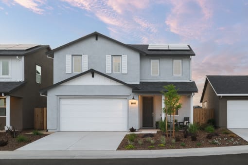a home with a white garage door in front of it
