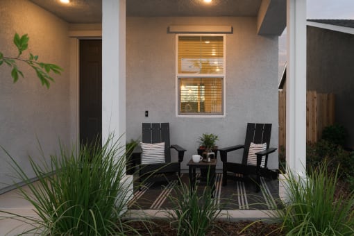 Fully-Furnished Single Family Homes For Rent In Roseville, CA - Cyrene At Fiddyment - Patio Area With Chairs, A Table, Pillars, And Beautiful Landscaping