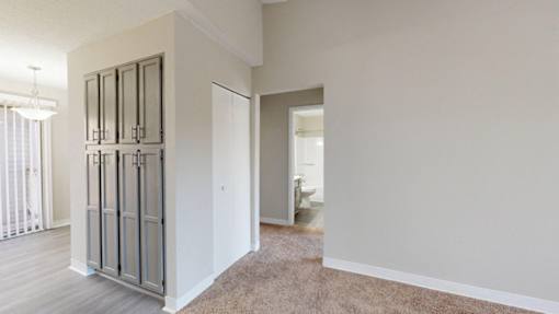 A room with a white wall and a carpeted floor.