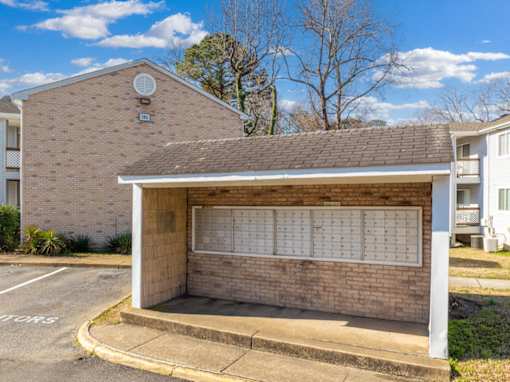 A brick building with a white awning and a calendar on the wall.