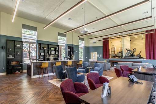 A room with a long table surrounded by chairs.
