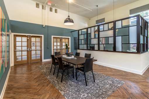 A dining room with a wooden table and chairs.