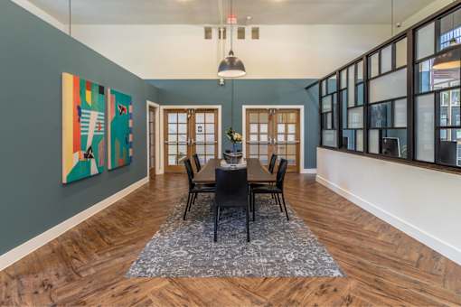 A dining room with a table set for four.