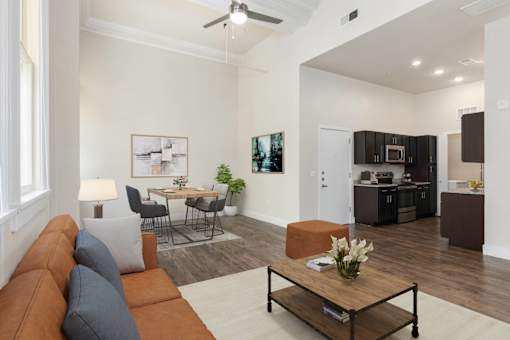 A living room with a brown couch and a coffee table.