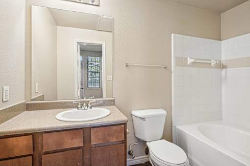 A bathroom with a white toilet and a white sink.
