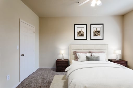 a bedroom with a large bed and two night stands