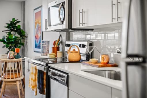 a kitchen with white cabinets and a sink
