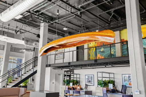 the lobby of a building with a large orange slide in the ceiling