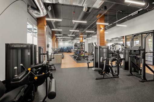 a gym with weights and other exercise equipment on the floor