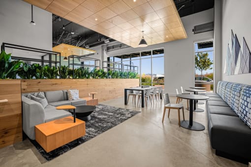 a living room with couches tables and chairs and a balcony