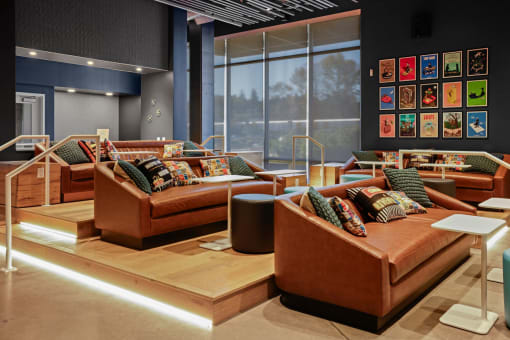 a living room with couches and tables and a large window