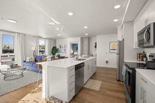 a kitchen with a white counter top and a living room
