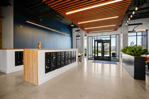 a reception area with a wooden desk and a glass door